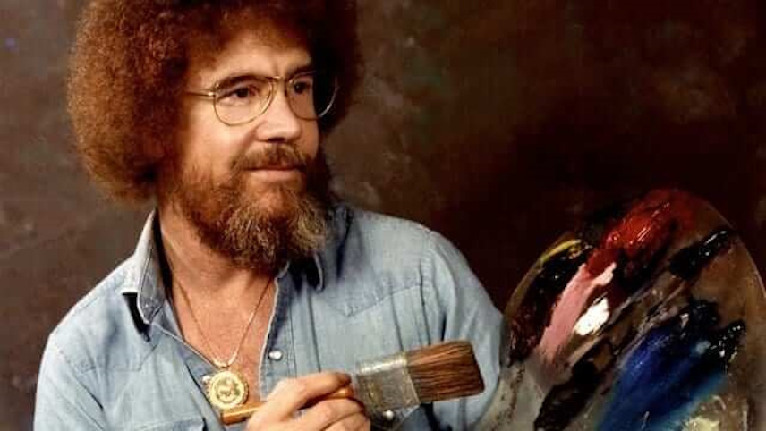 Bob Ross holding a paintbrush